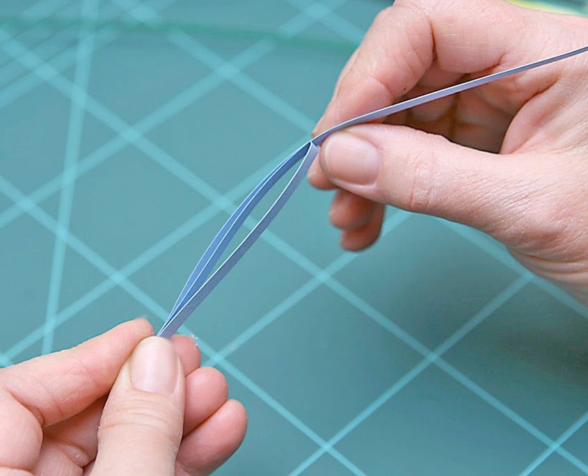 Mavi quilling şeridi uzun bir halka yapılıp uçlarından çekilerek vazo kenarı hazırlanıyor