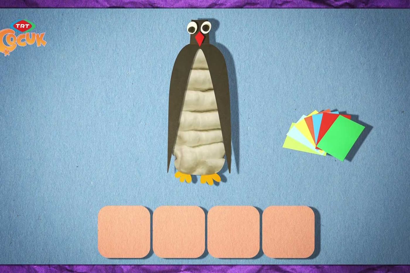 Programın malzeme animasyonundan kare: pamuklu şişe penguen çizimi ve renkli karton kağıtlar