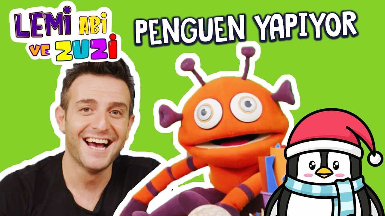 Çorap penguen video kapağı: gülümseyen sunucu, turuncu uzaylı kukla ve kırmızı şapkalı çizgi penguen